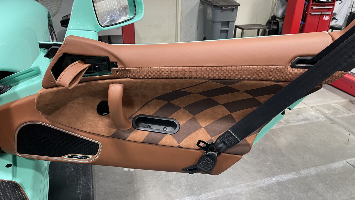 Custom Dodge Viper door panel upholstered in checkered suede and woven tan leather